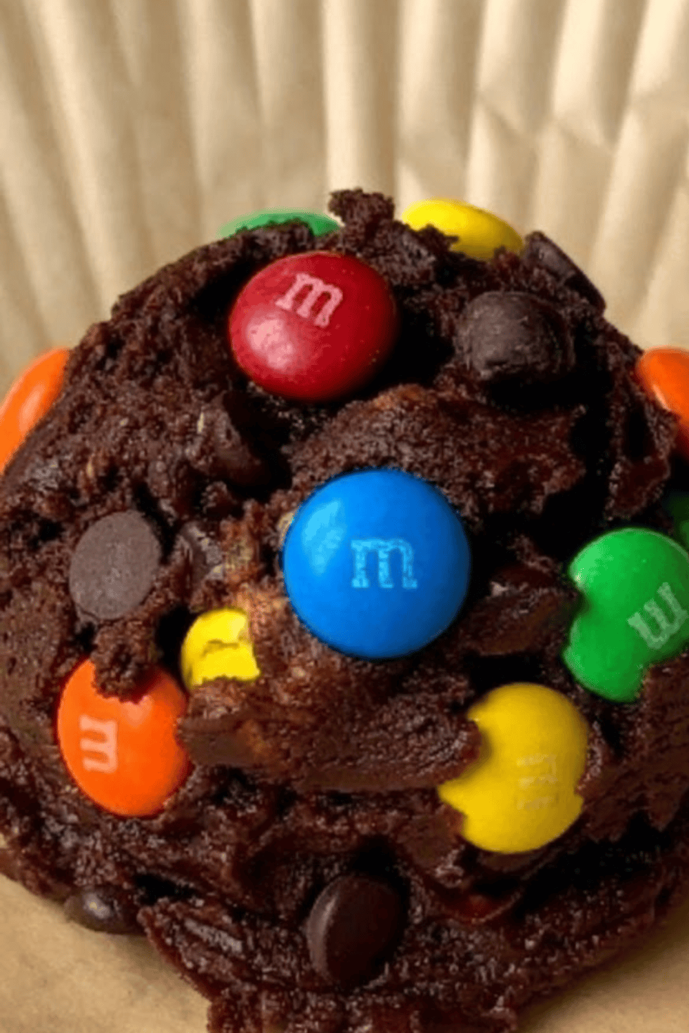 Chewy air fryer monster cookies with chocolate chips and colorful M&M’s stacked on cooling rack.