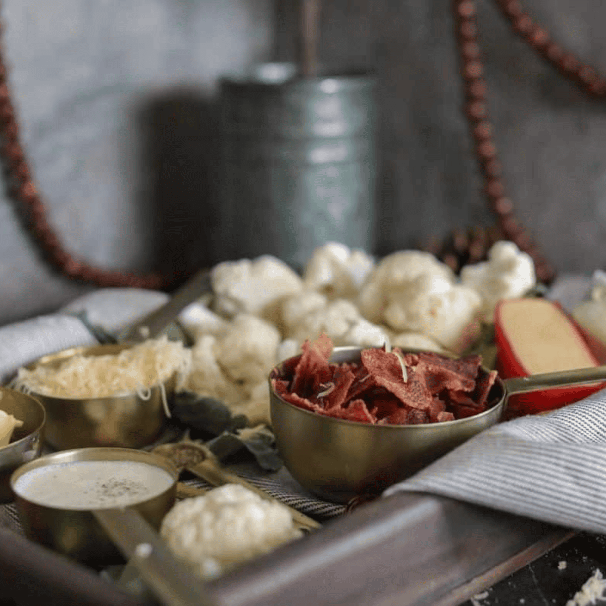 Ingredients needed for Easy Air Fryer Roasted Cauliflower Mash on kitchen table.