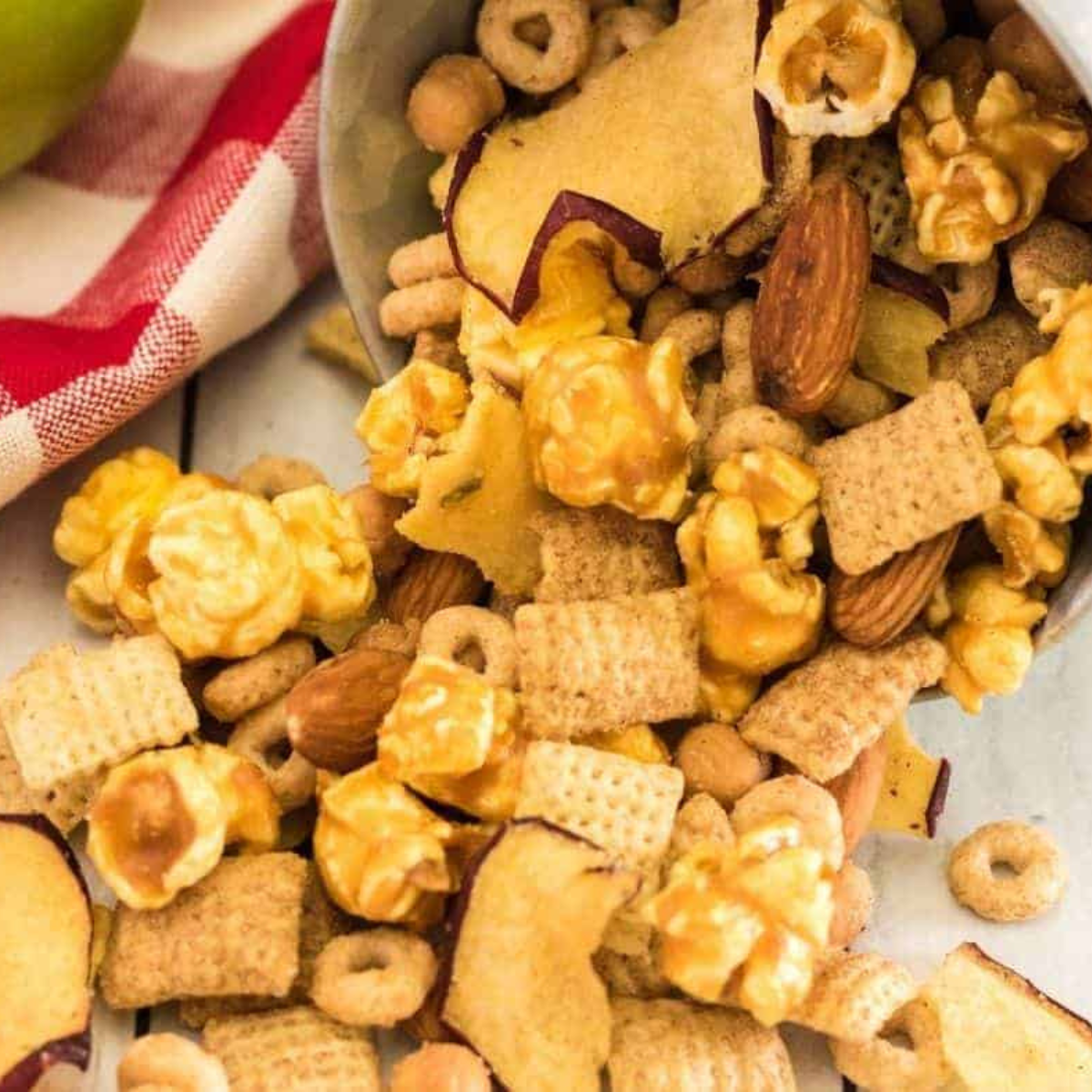 Caramel apple trail mix cooling in a single layer on a parchment-lined sheet pan