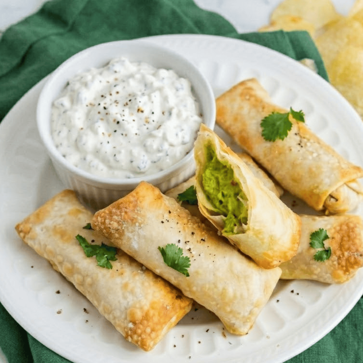 crispy golden air fryer avocado egg rolls filled with creamy avocado and cheese