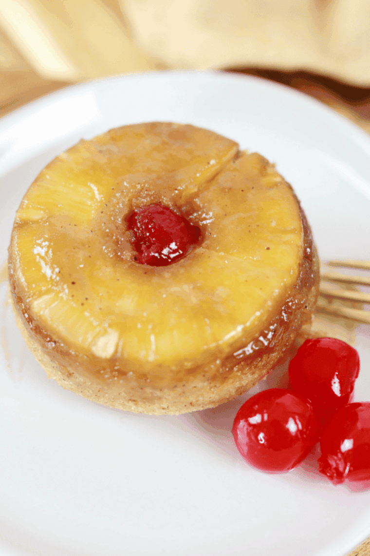 Air Fryer Pineapple Upside-Down Cake for Two with caramelized pineapple and cherry on top, served in a ramekin.