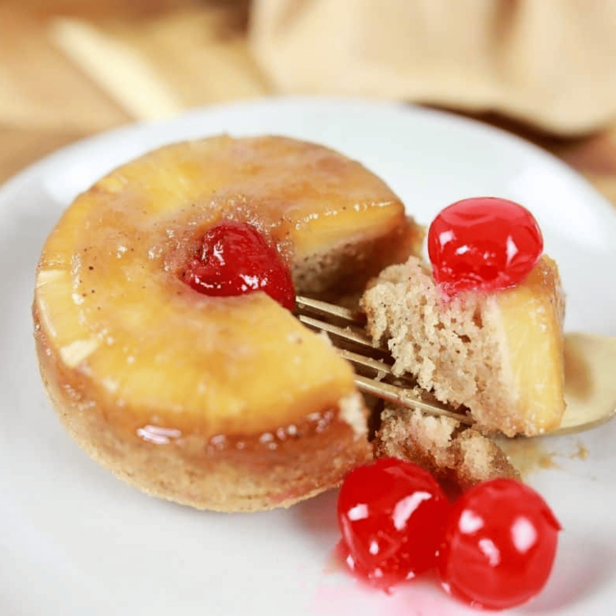 Air Fryer Pineapple Upside-Down Cake for Two with caramelized pineapple and cherry on top, served in a ramekin.