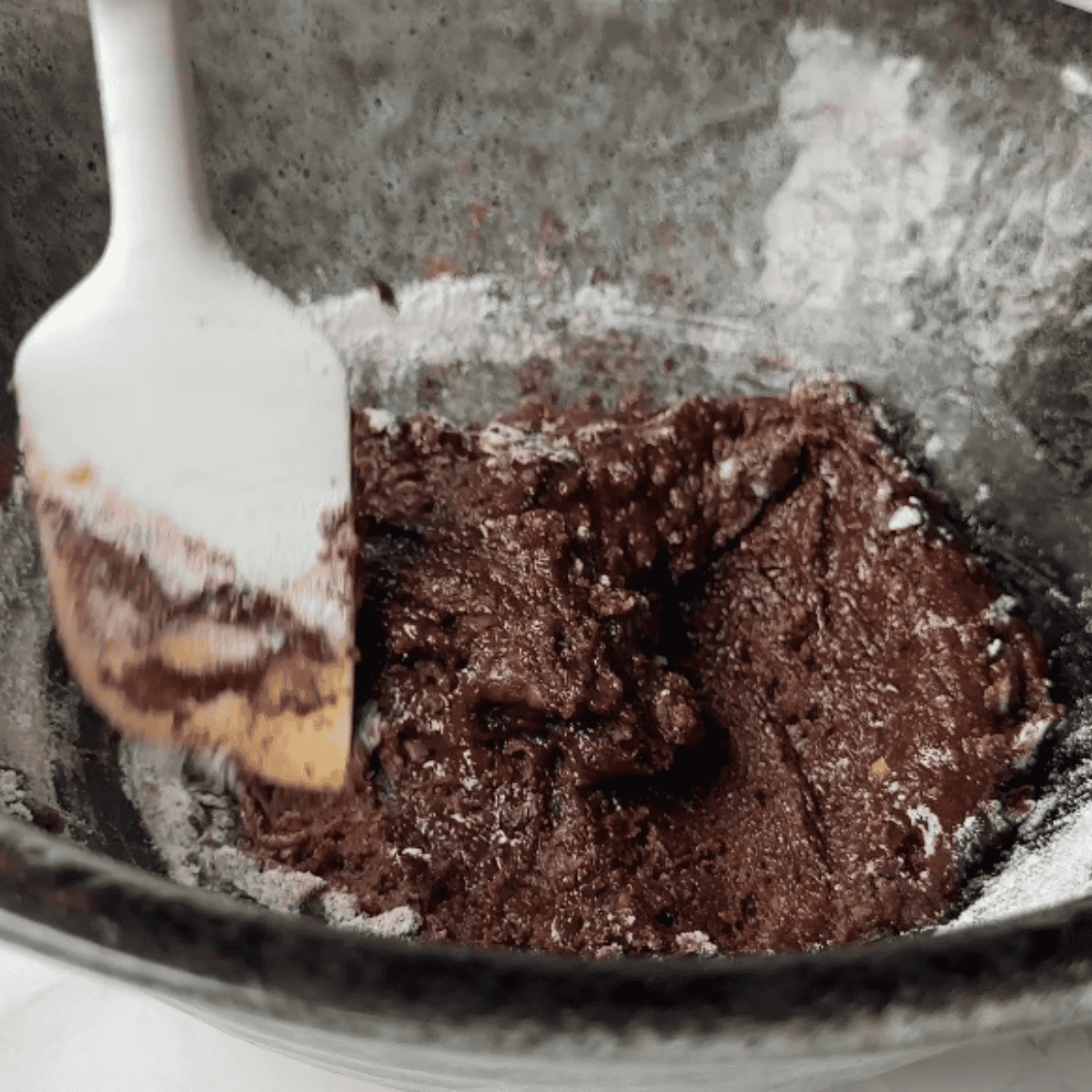 Mixing cookie dough with butter, sugars, egg, vanilla, flour, and graham cracker crumbs in separate bowls.
