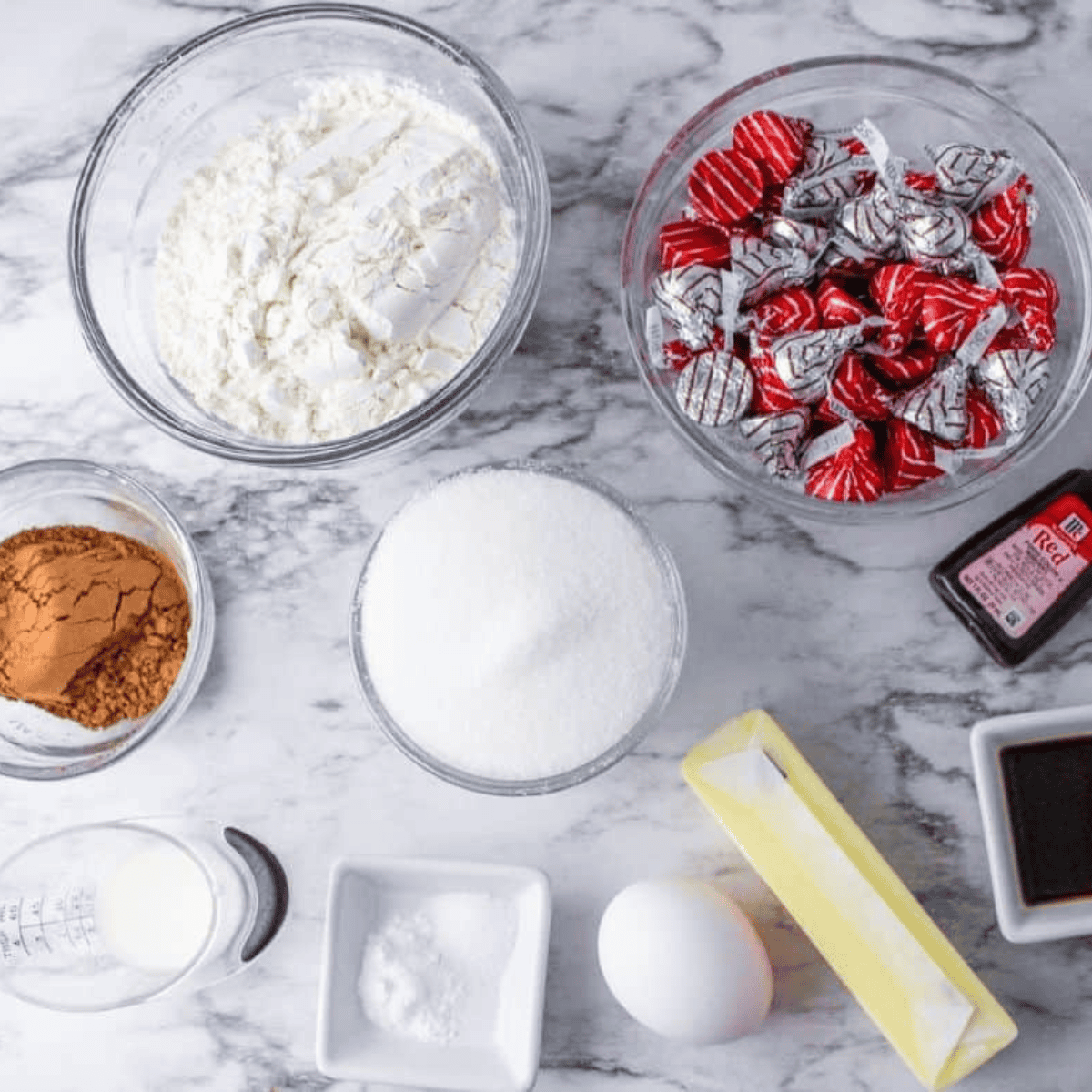 Ingredients needed for Air Fryer Hershey’s Red Velvet Blossom Cookies on kitchen table.