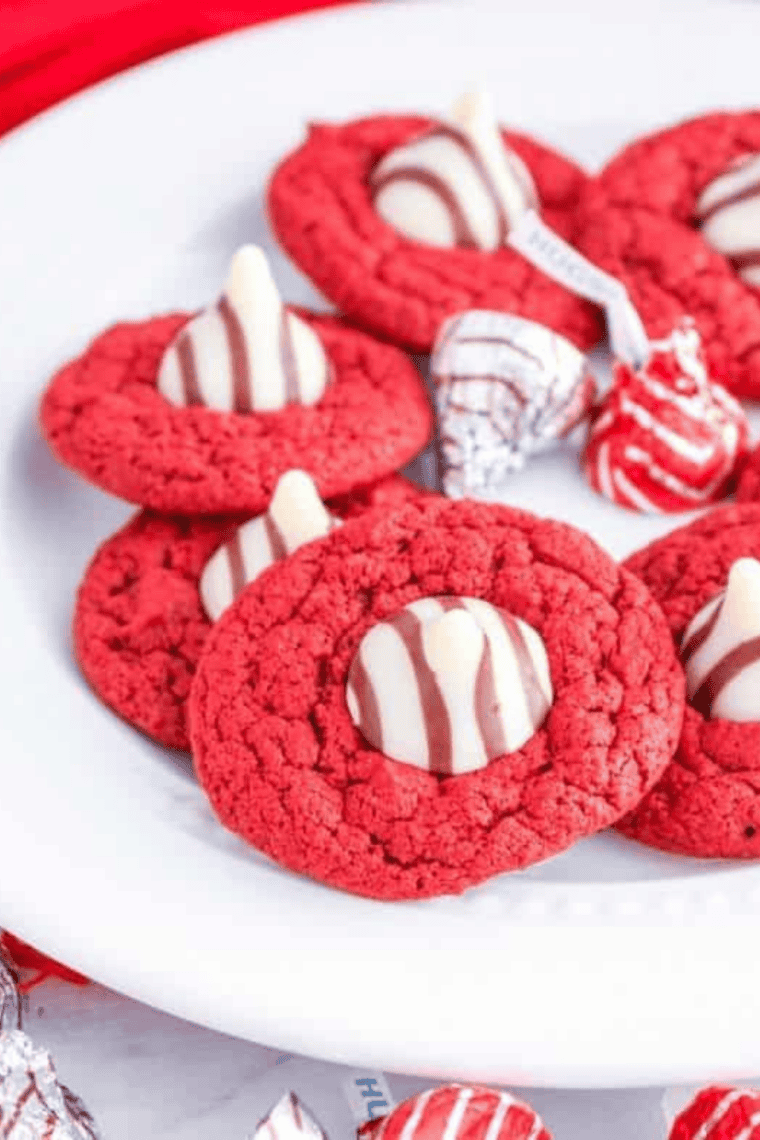 Air Fryer red velvet blossom cookies with Hershey’s chocolate kisses in the center.