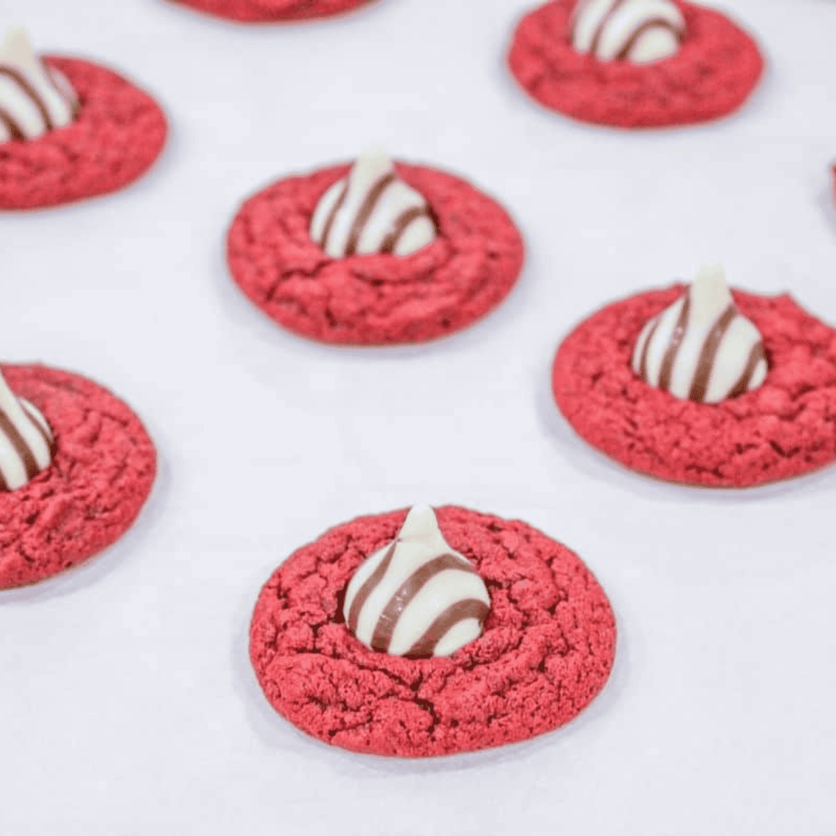 Air Fryer red velvet blossom cookies with Hershey’s chocolate kisses on top.