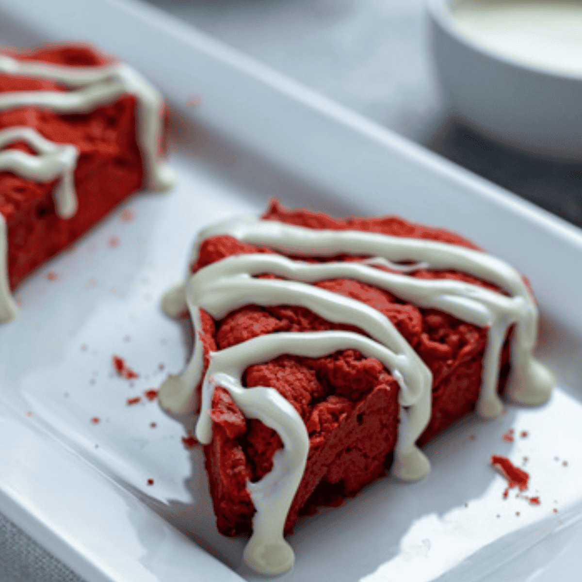 Freshly baked Air Fryer Red Velvet Scones, golden on the edges and drizzled with icing.