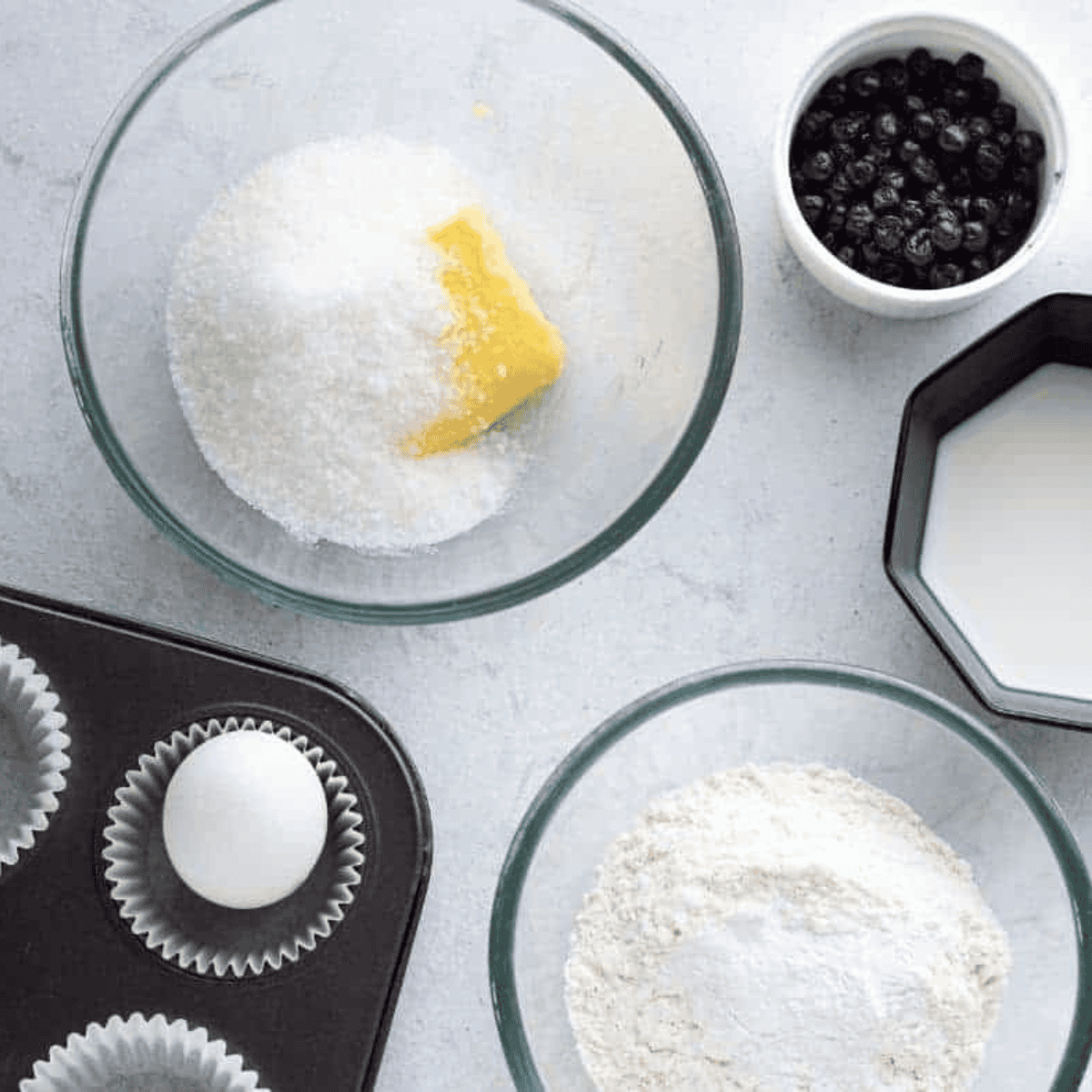 Ingredients needed for Air Fryer Blueberry Cupcakes on kitchen table.