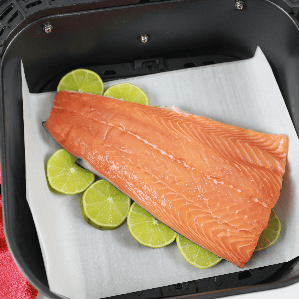 Raw salmon fillets rubbed with olive oil and seasoned with salt and pepper