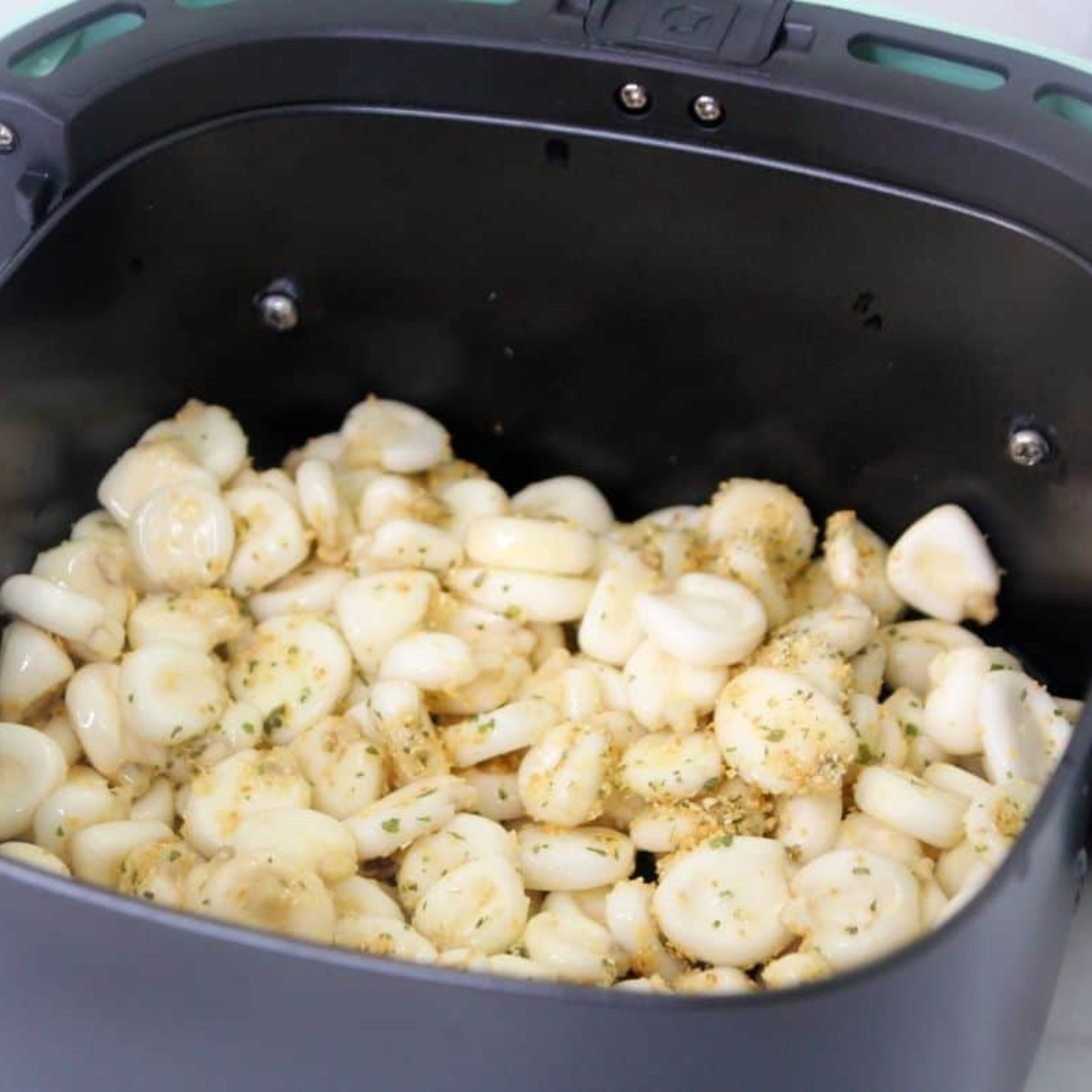Air frying seasoned hominy at 400°F with shaking every 5 minutes until deeply golden brown and crispy throughout
