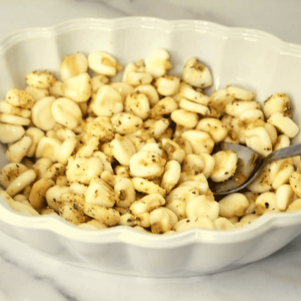 Low-temperature oven drying hominy after soaking to eliminate moisture for maximum crispiness in air fryer corn nuts