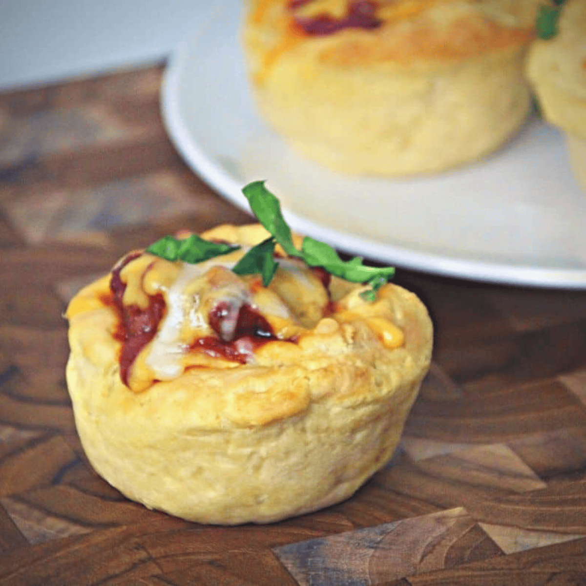 Air fryer Sloppy Joe cups in a muffin tin, filled with savory ground beef mixture and melted cheese, ready to serve.