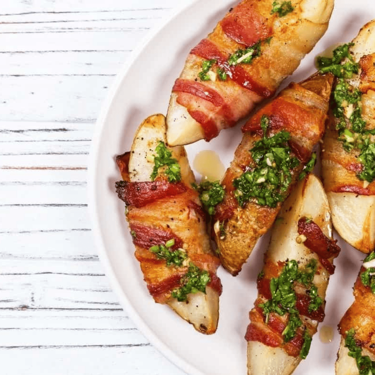 Air Fryer bacon wrapped potato wedges cooked until crispy and golden with smoky bacon wrapped around each wedge