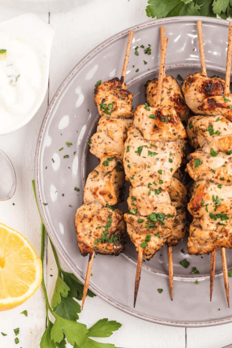 Juicy Air Fryer Greek Chicken Kebabs threaded with red bell pepper and onion, garnished with fresh parsley