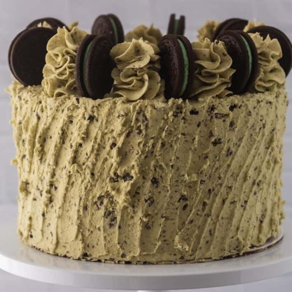 Air Fryer Mint Chocolate Cookies ’n Creme Cake with mint frosting and cookie crumbles