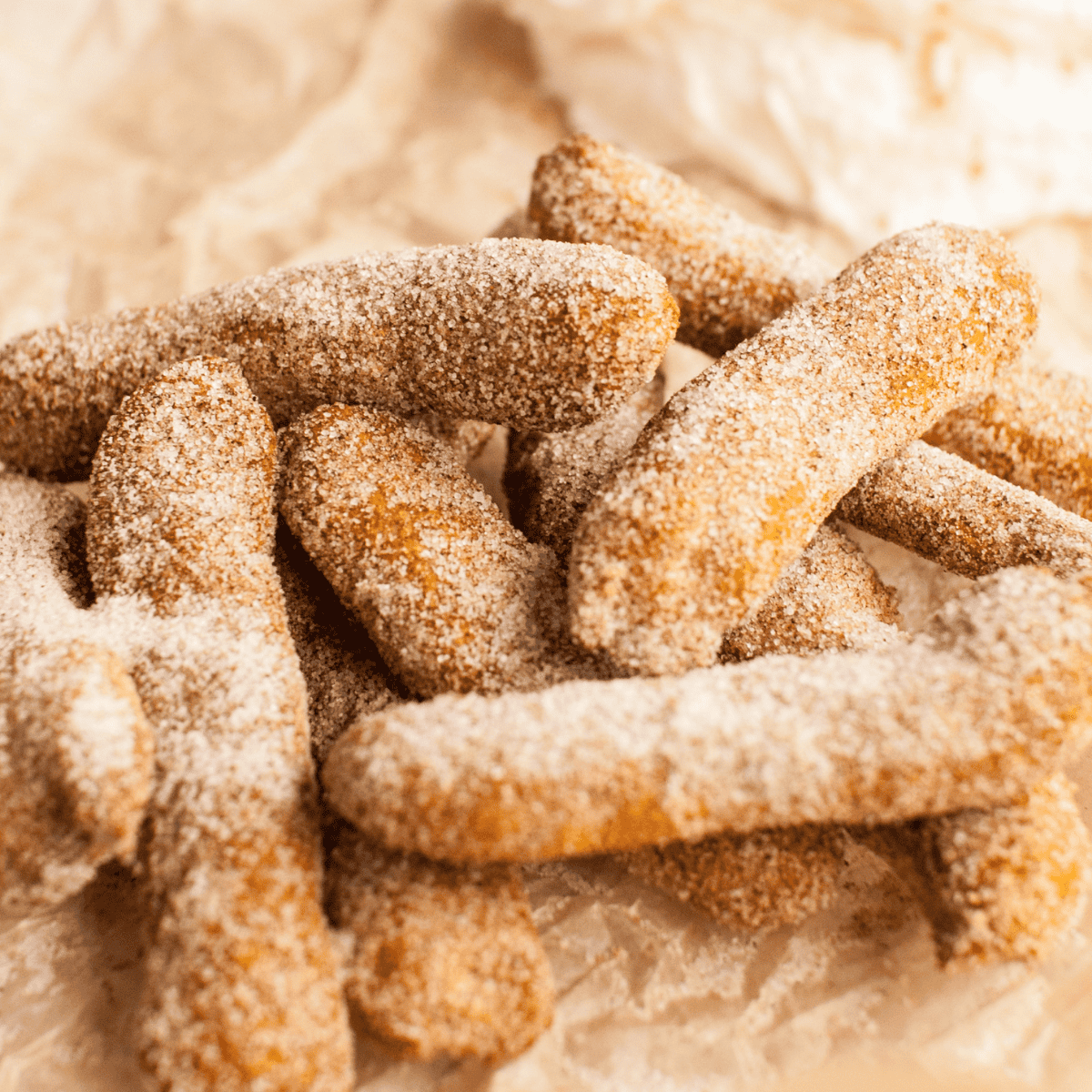 A plate of warm Air Fryer Pumpkin Churros served with cream cheese frosting dip