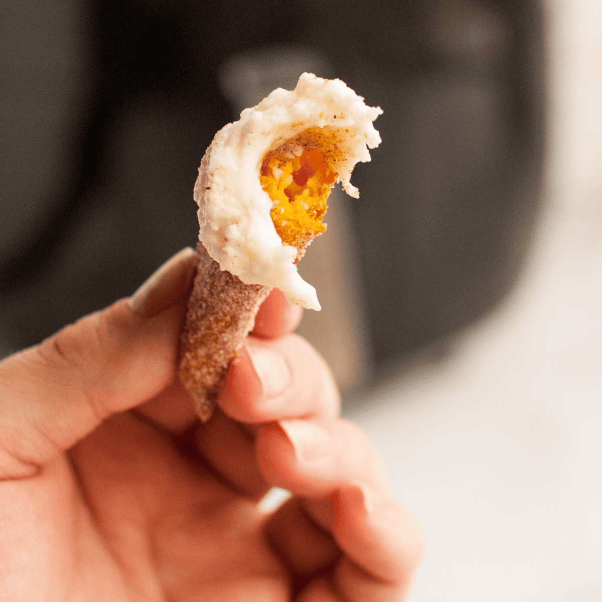 Golden no-fry Air Fryer Pumpkin Churros piled on parchment paper for fall