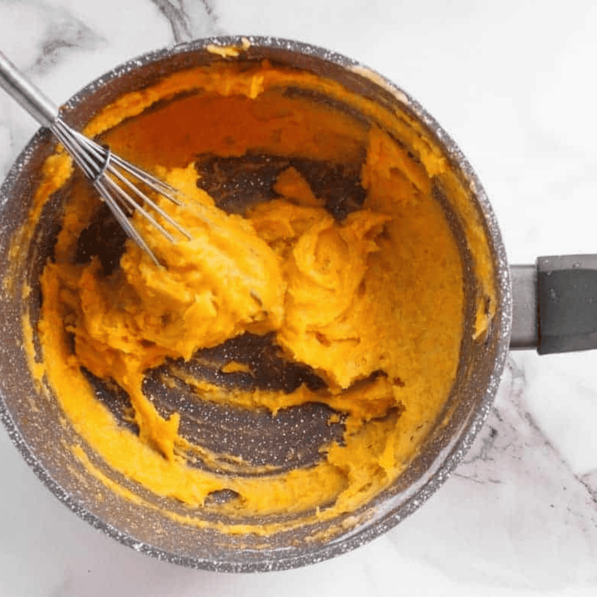 Incorporating the egg into the churro dough mixture.