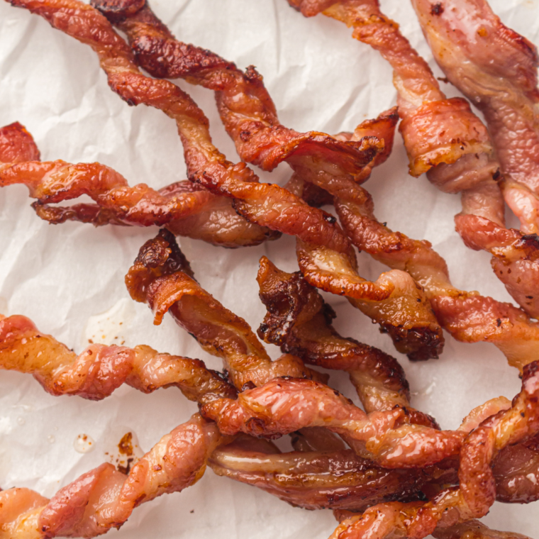Hero Image Air fryer twisted bacon strips cooked in a spiral shape until crispy caramelized and golden brown for a viral TikTok style bacon upgrade