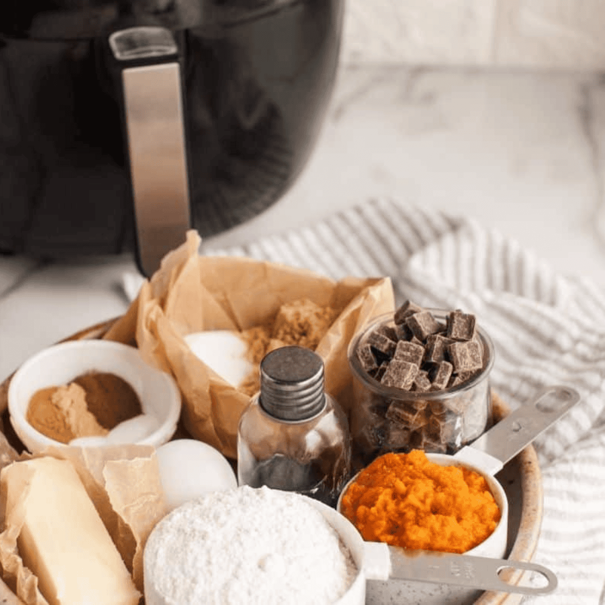 Ingredients needed for Air Fryer Pumpkin Chocolate Chunk Sandwich Cookie on kitchen table.