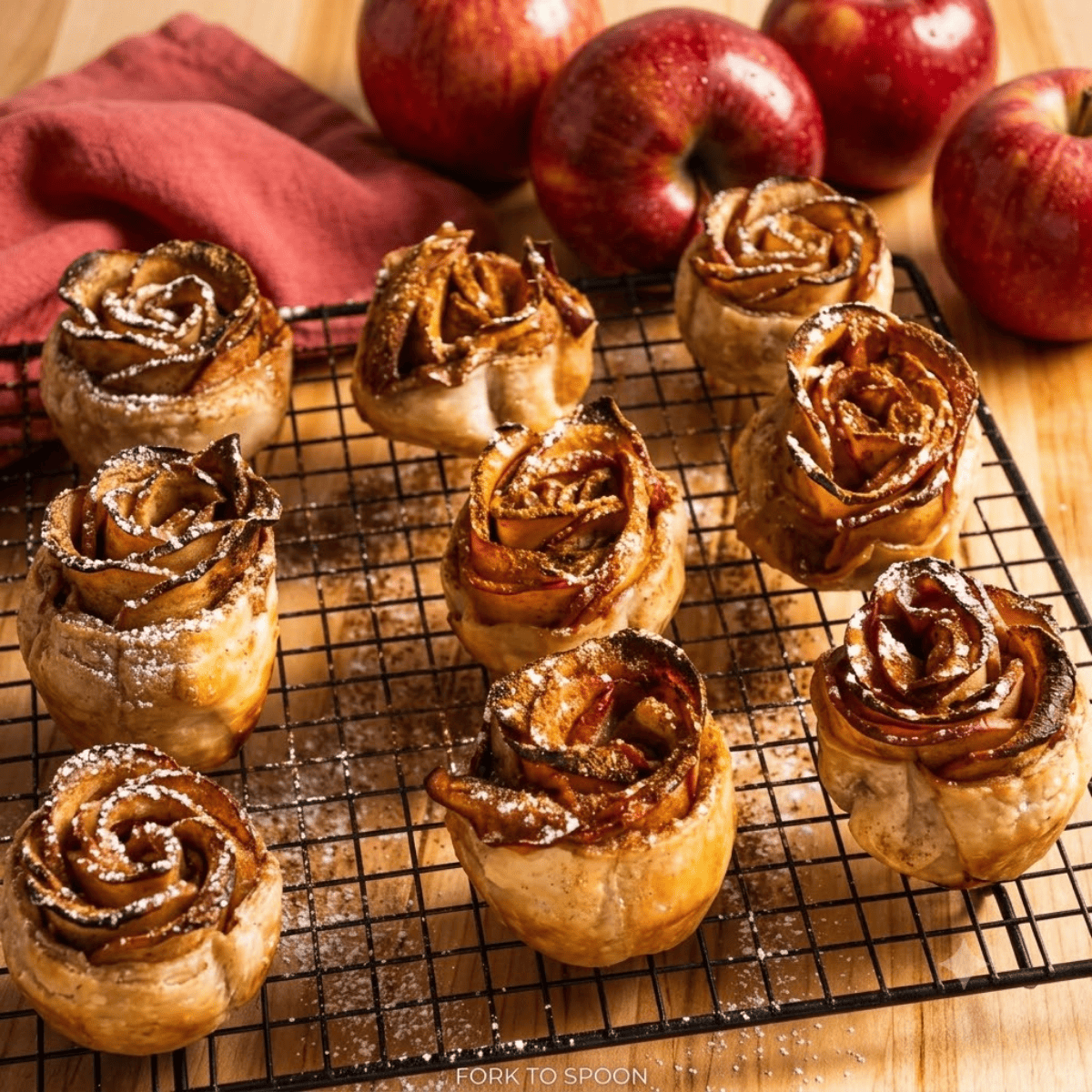 Close-up of a baked apple rose showing flaky golden puff pastry petals
