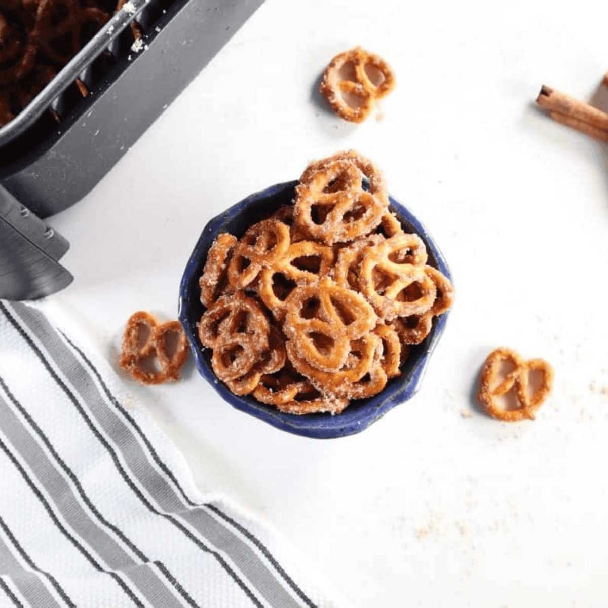 Air fryer cinnamon sugar pretzels cooling on a wire rack after air frying.