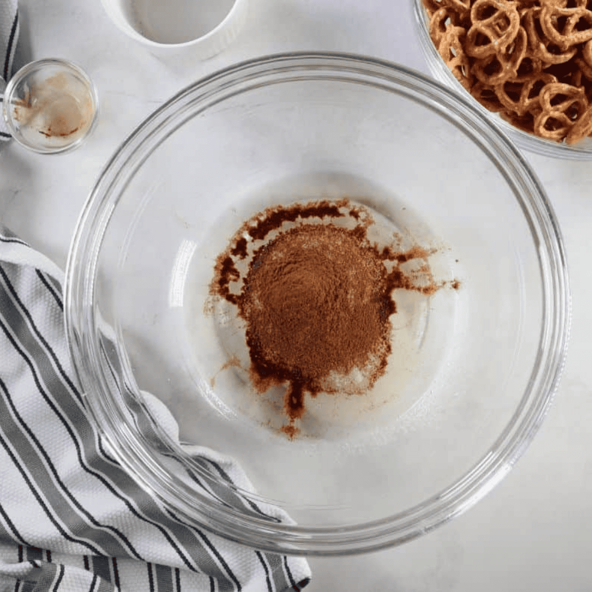 Pretzels tossed in the cinnamon sugar coating in a mixing bowl until evenly covered.