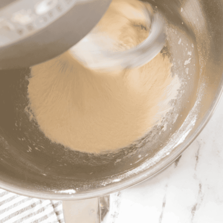 flour, salt, and olive oil added to yeast mixture forming sticky dough