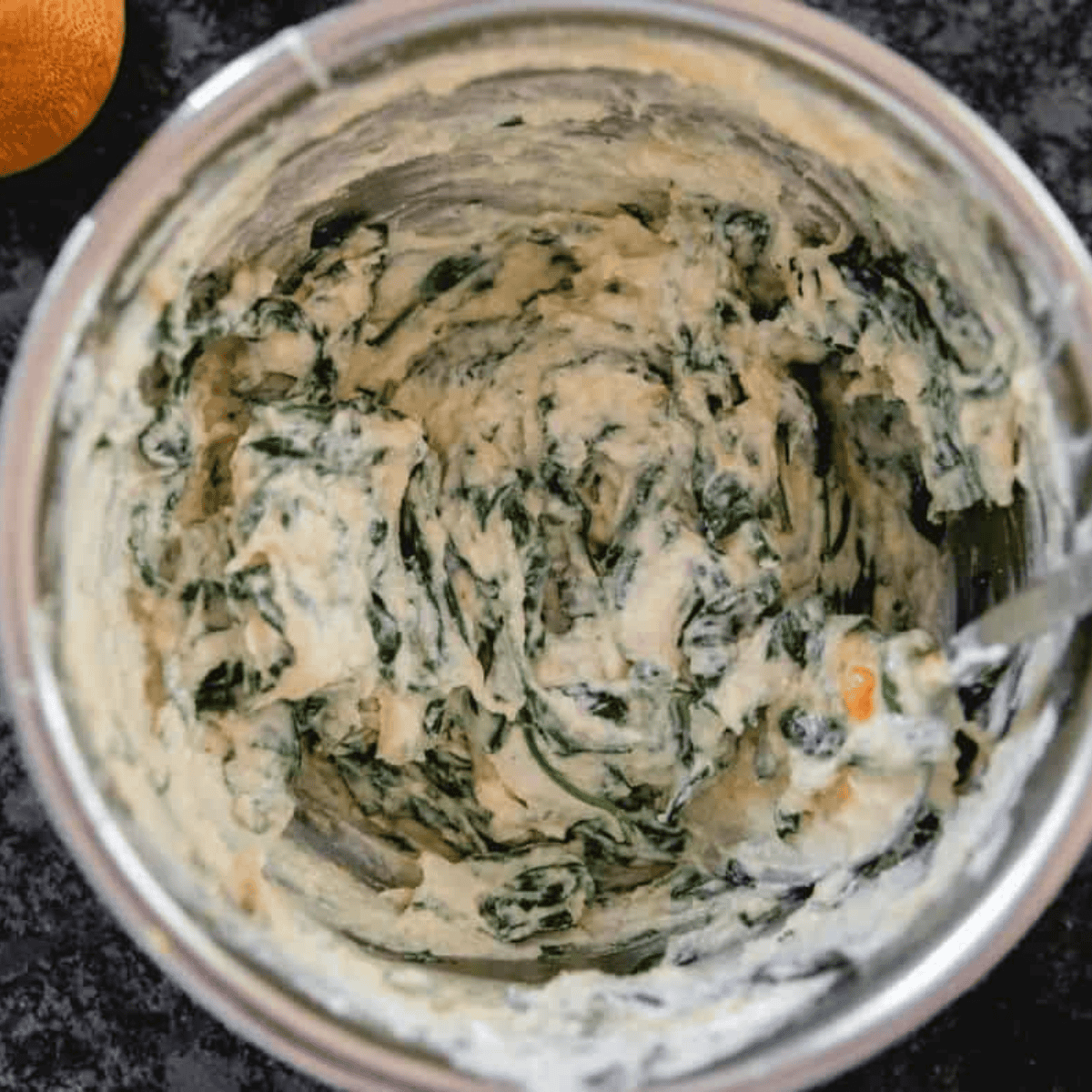 Spinach and ricotta filling mixed with Parmesan and mozzarella in a bowl