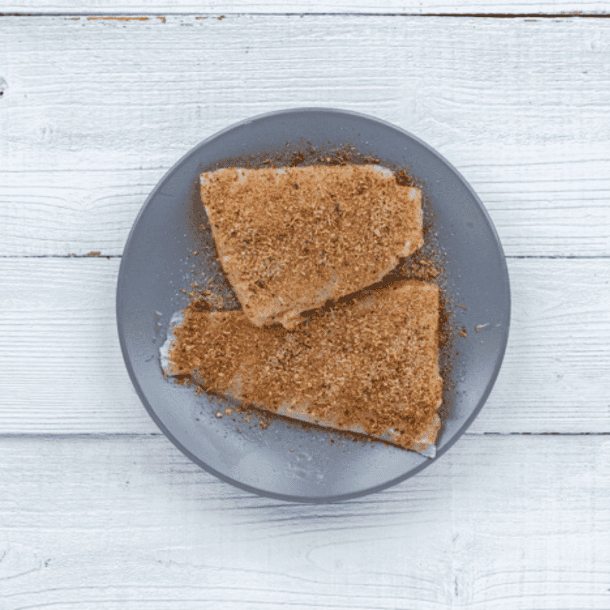 Swai fish fillets brushed with olive oil and seasoned with blackened or Cajun spice mix before cooking in air fryer
