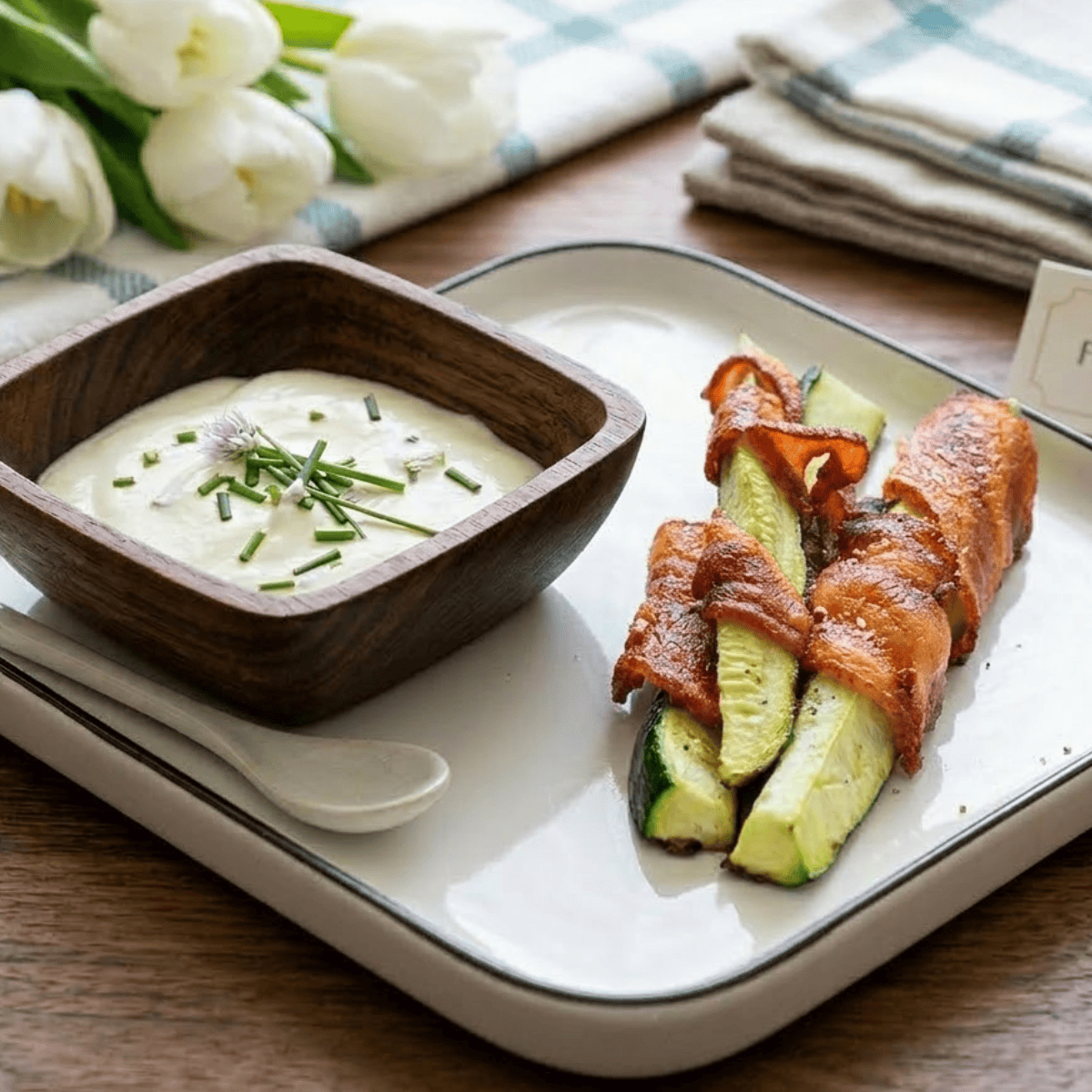 Air fryer bacon wrapped zucchini low carb keto appetizer with crispy bacon and tender zucchini pieces.