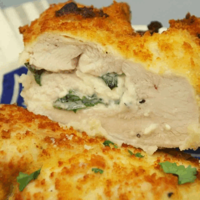 Air Fryer Feta and Spinach Stuffed Chicken Breasts plated with golden crust and melted cheese inside.