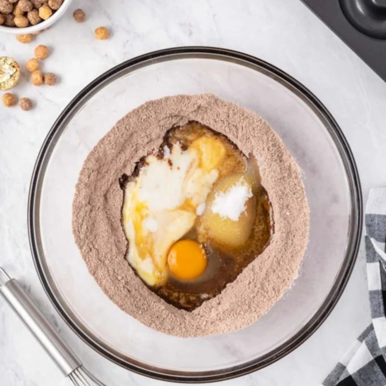 Melted butter, egg, buttermilk, and vanilla poured into a well in the center of the dry ingredients