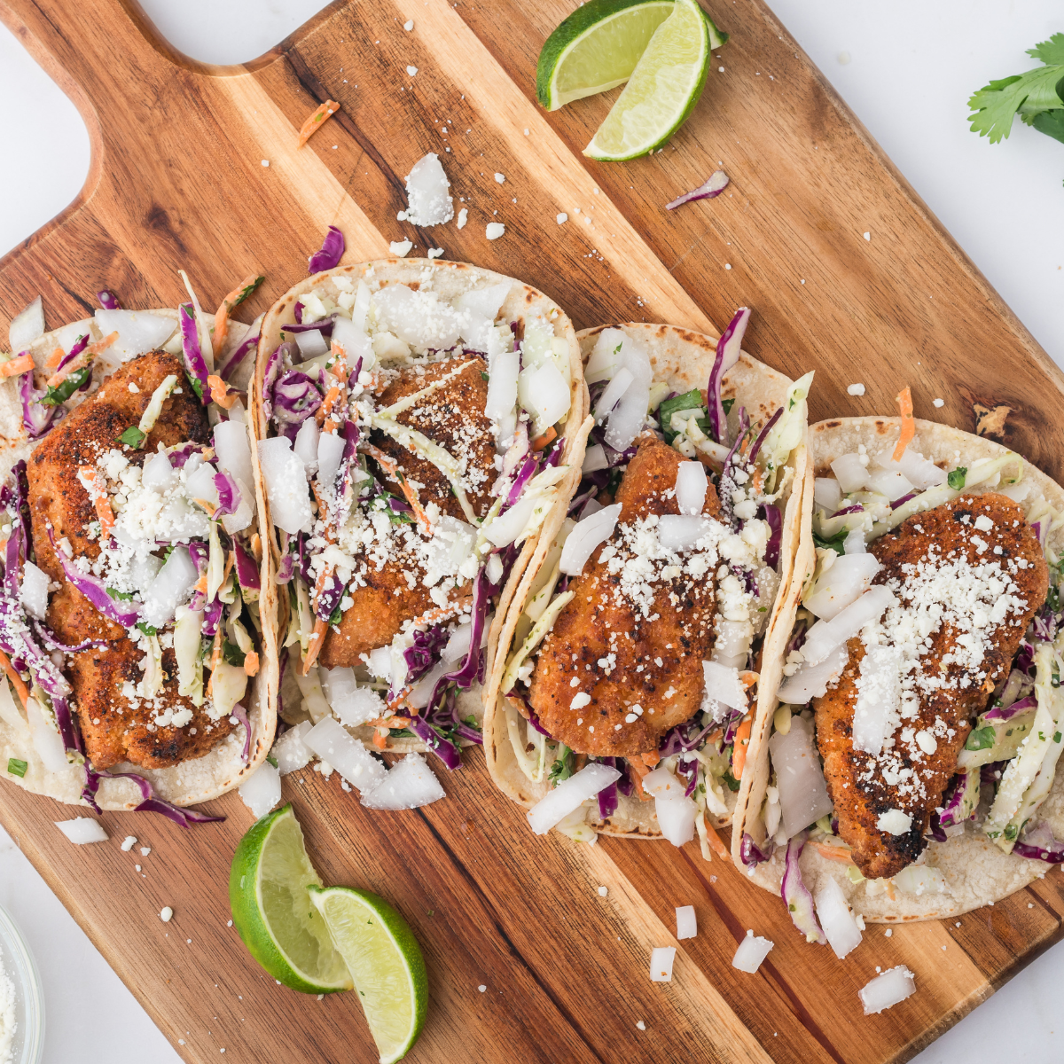 Trader Joe's air fryer fish nuggets in tacos with cabbage slaw and lime
