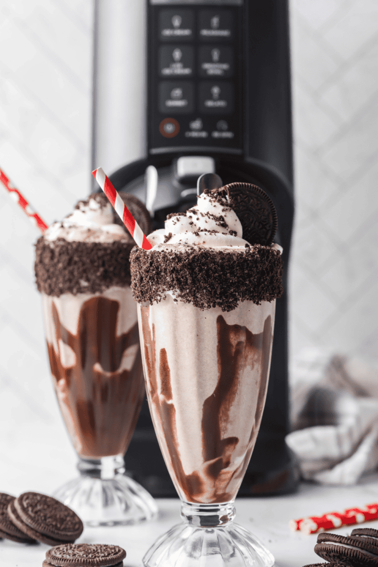 A bowl of rich, glossy chocolate sauce drizzled over vanilla ice cream.