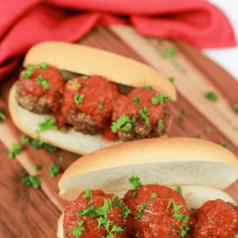 Homemade Maggiano’s-style meatballs in rich marinara sauce served on a plate, ready to eat.