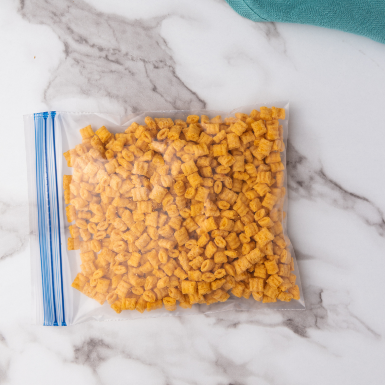 Prepare the Coating: Crushed Cap’n Crunch cereal mixed with cinnamon and sugar in a shallow bowl..
