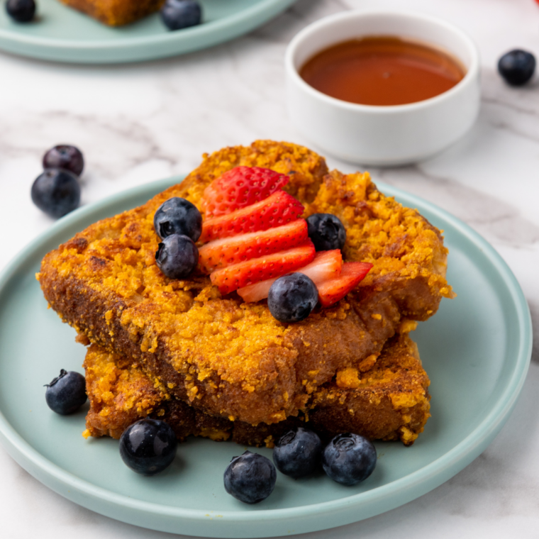Air fryer Captain Crunch French toast slices, golden brown and crispy, served on a plate with syrup