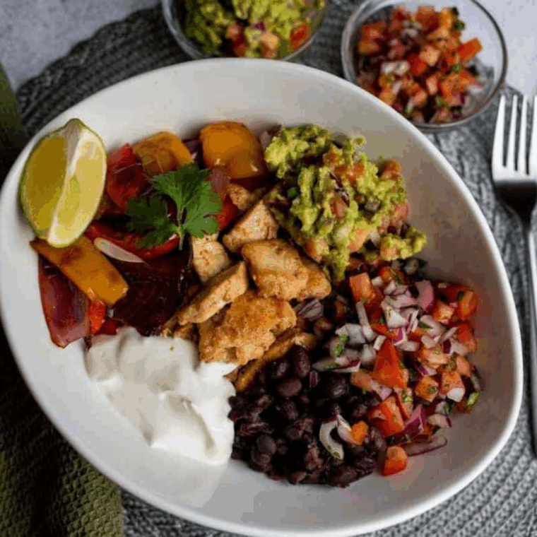 Air Fryer Chicken Fajita Rice Bowl with colorful peppers, onions, and seasoned chicken over rice