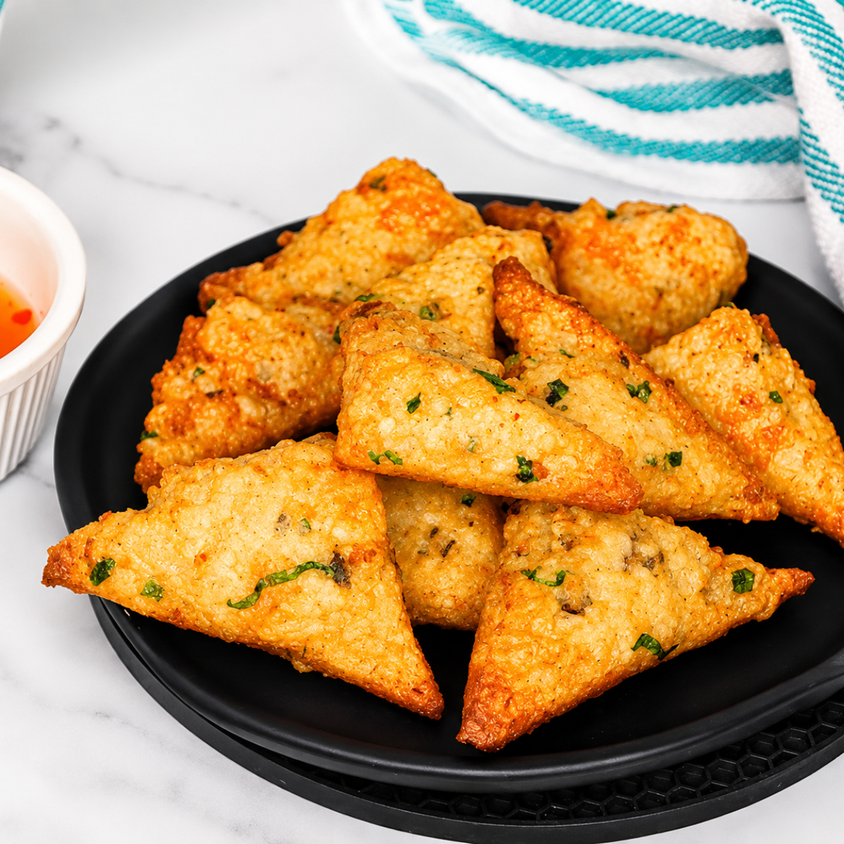 Plate of air fryer frozen shrimp toast with a small bowl of dipping sauce