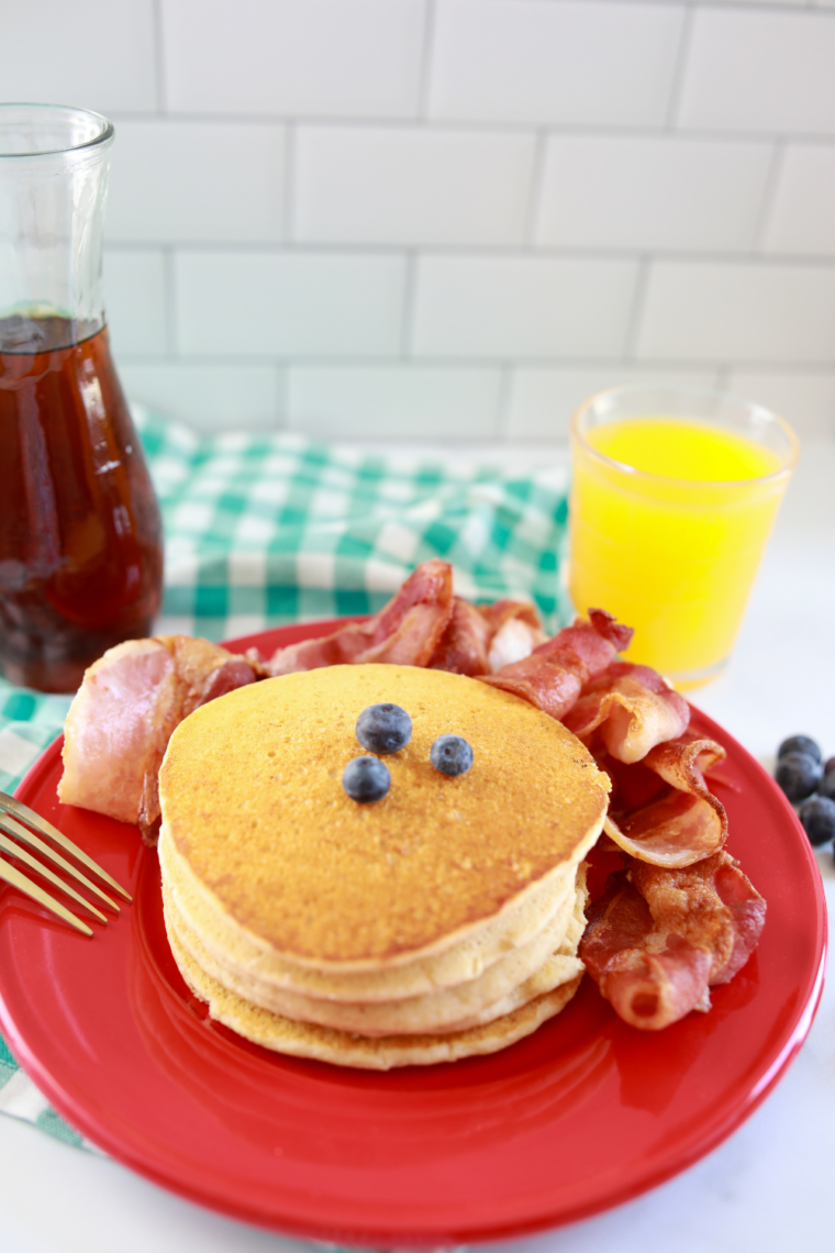 Pancakes reheating in air fryer basket until warm and golden