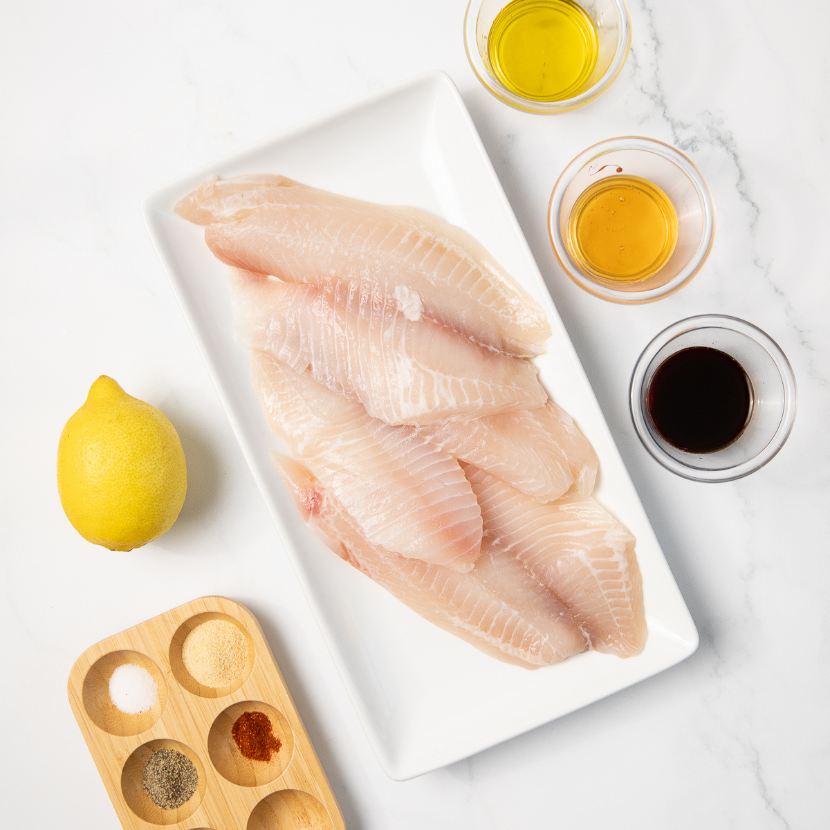Ingredients needed for Easy Air Fryer Walleye No Breading on kitchen table.