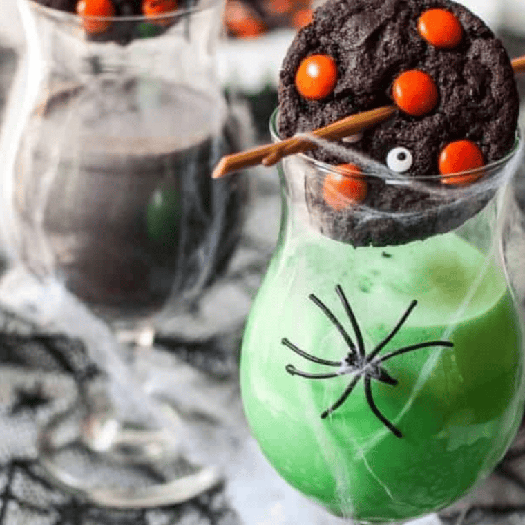 Thick, dark chocolate Halloween cookies loaded with orange and green sprinkles and white chocolate chips, freshly baked and soft inside.