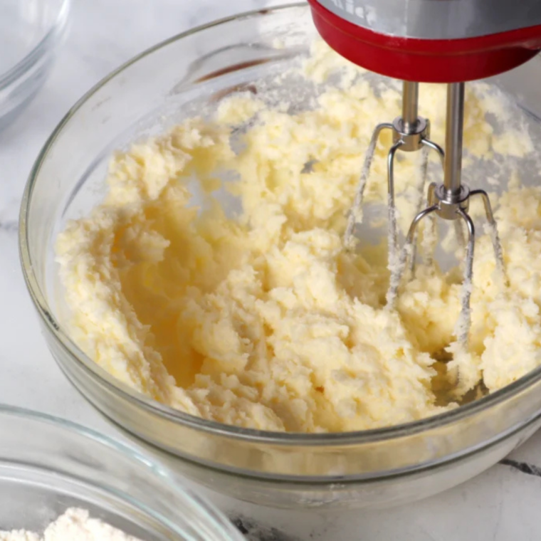 Mixing pumpkin puree, eggs, sugars, oil, and dry ingredients together in bowls to make Air Fryer Pumpkin Whoopie Pie batter.