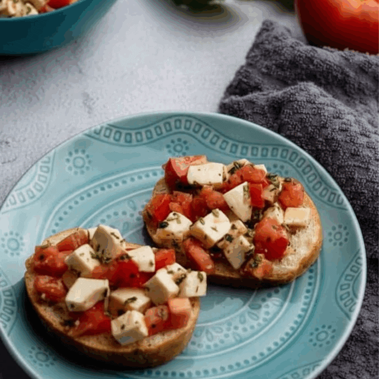 Air fryer tomato and buffalo mozzarella bruschetta on toasted bread topped with basil