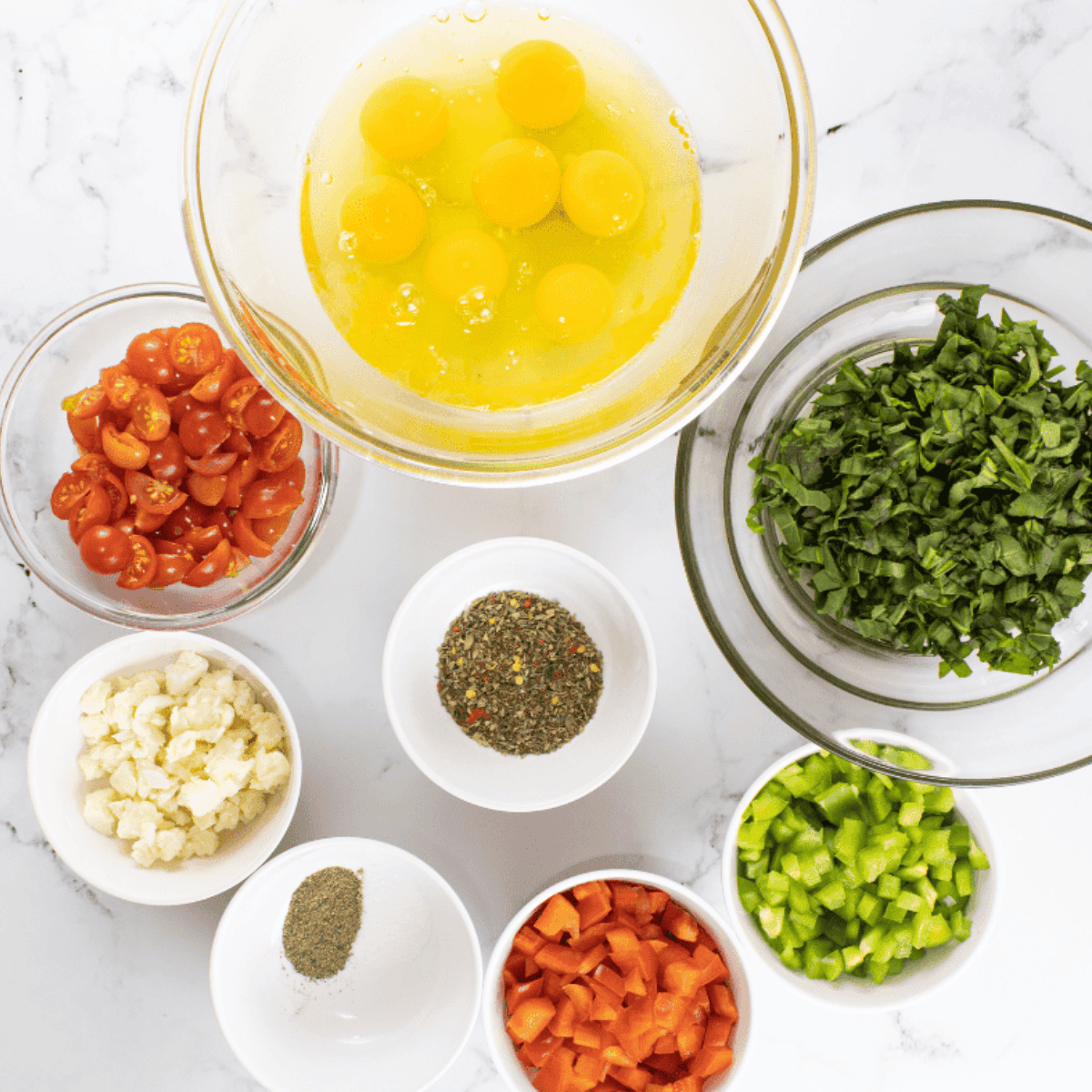 Ingredients needed for Air Fryer Vegetable Savory Muffins on kitchen table.