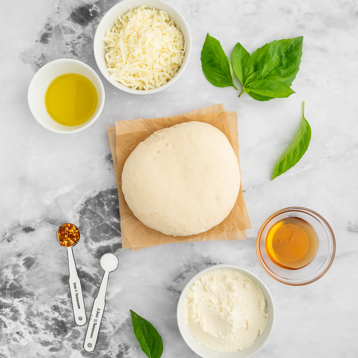 Ingredients needed for Easy Air Fryer Mummy Pizza (The Cutest Halloween Recipe!) on kitchen table.