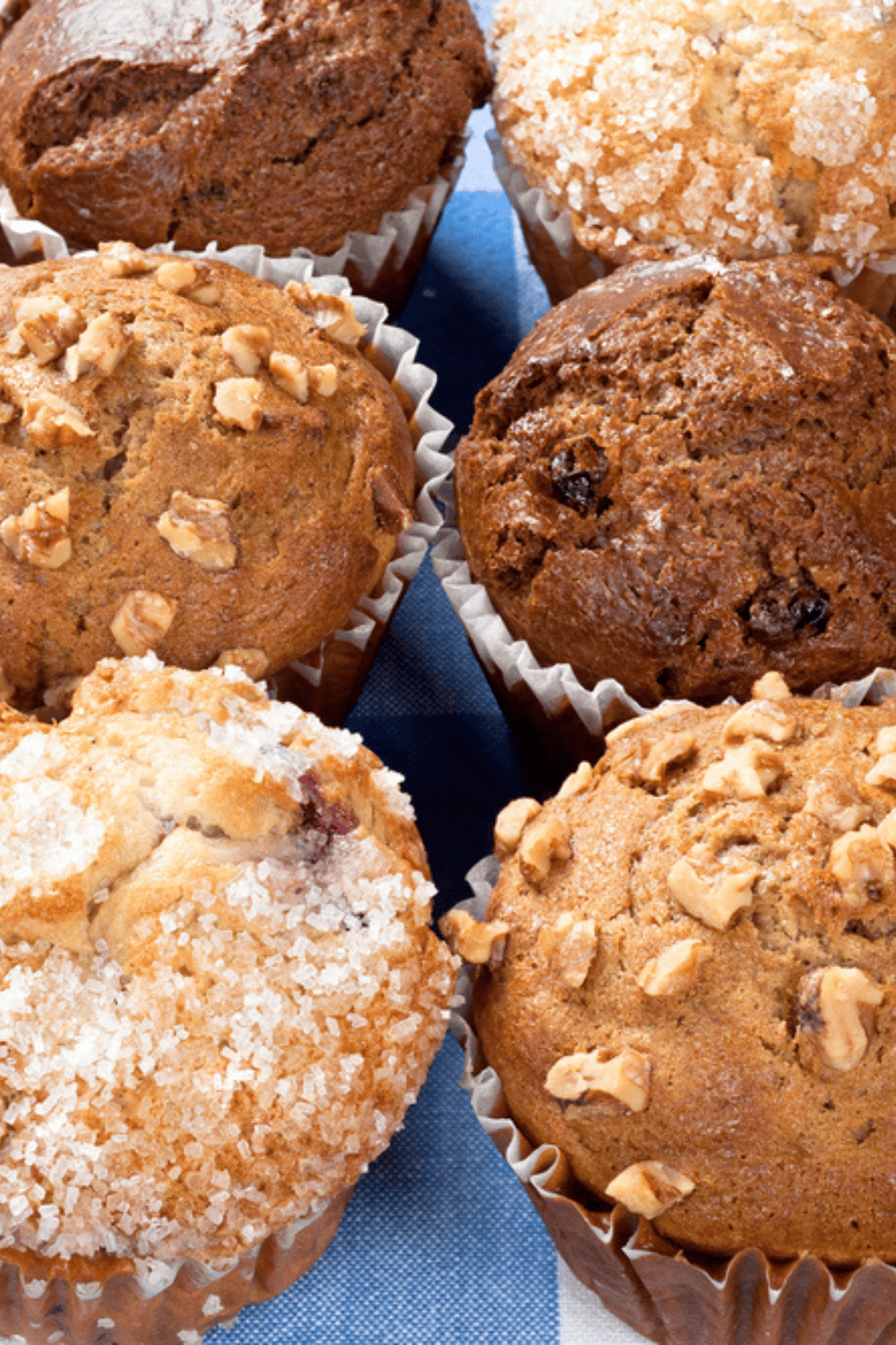 Morning glory muffins lined up in rows on a wooden table after air frying
