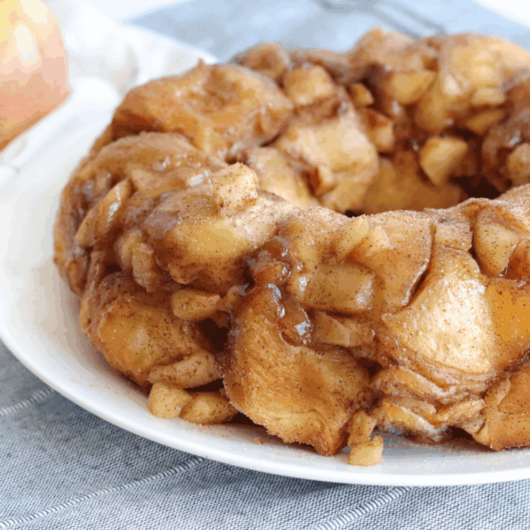 Golden, pull-apart apple cinnamon monkey bread fresh from the air fryer, drizzled with glaze.