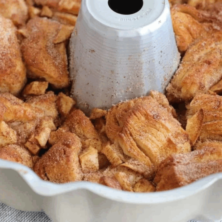 Golden, pull-apart apple cinnamon monkey bread fresh from the air fryer, drizzled with glaze.